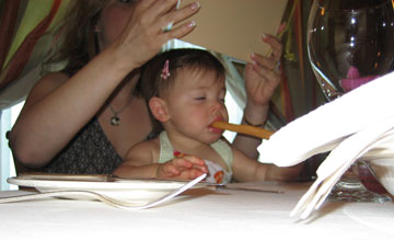 kirsten enjoying her pre-meal bread stick
